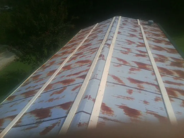 Rusted metal roof panels with new wood purlins before replacement — Storm Damage Roof Repair in Gibsonton by Roofing Brothers